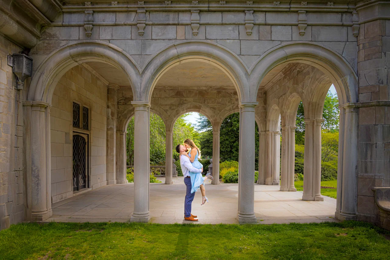 Engagement session couple kissing under stone arches — George Pompilio Photography